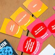 No Filter adult phrase cards spread across a wooden table
