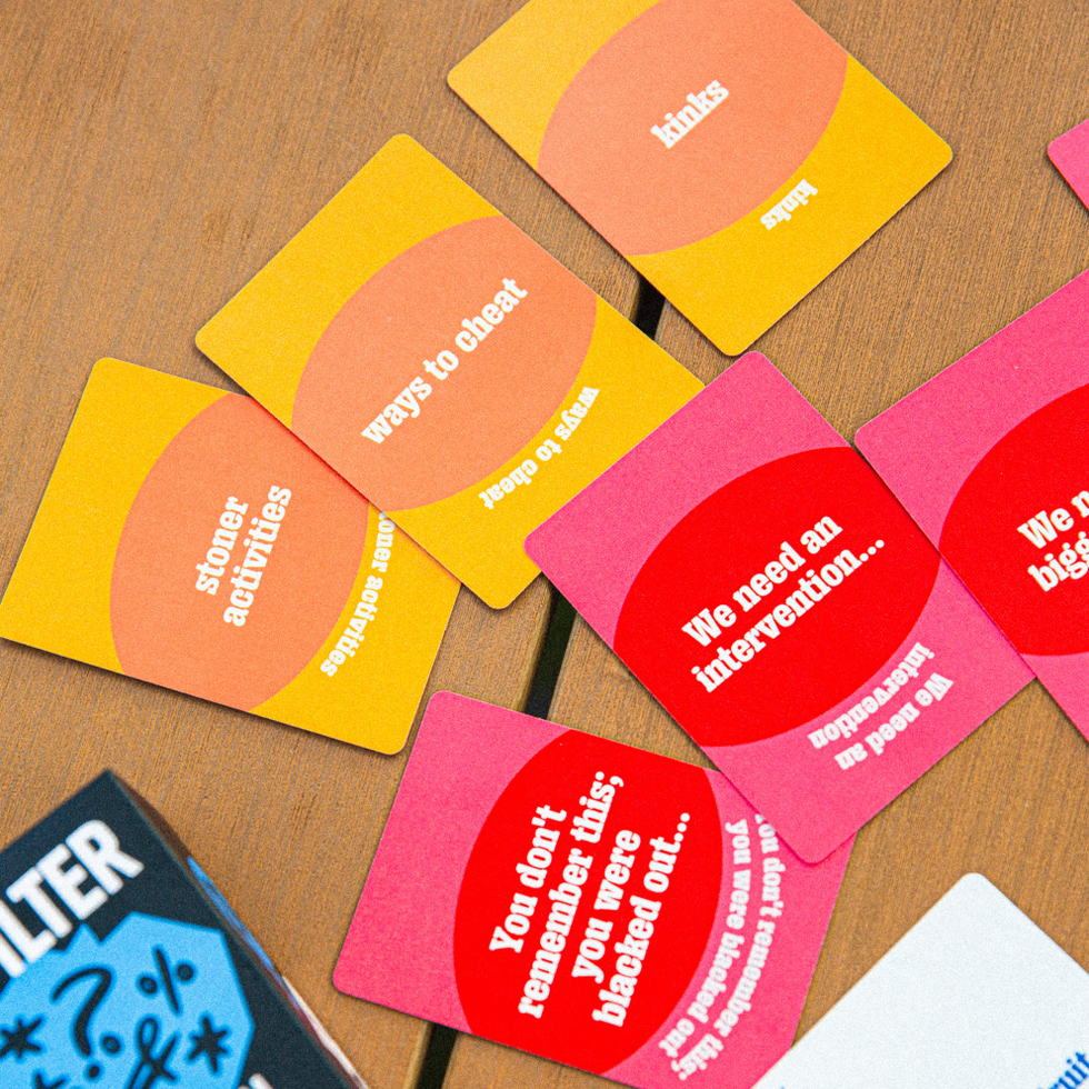 No Filter adult phrase cards spread across a wooden table