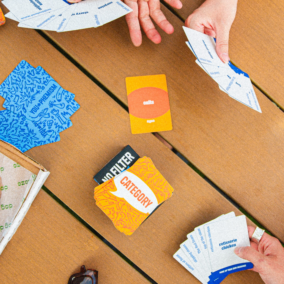 Players using You-phemism and No Filter cards at a table
