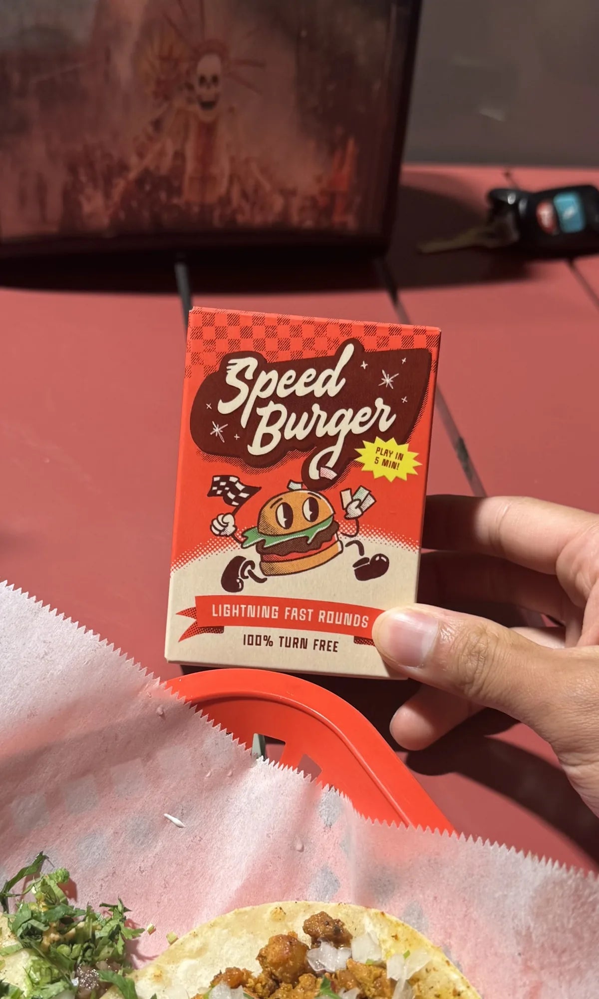 Speed Burger box held above a taco tray